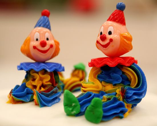 Colorful clowns made out of icing to go on a cake. 