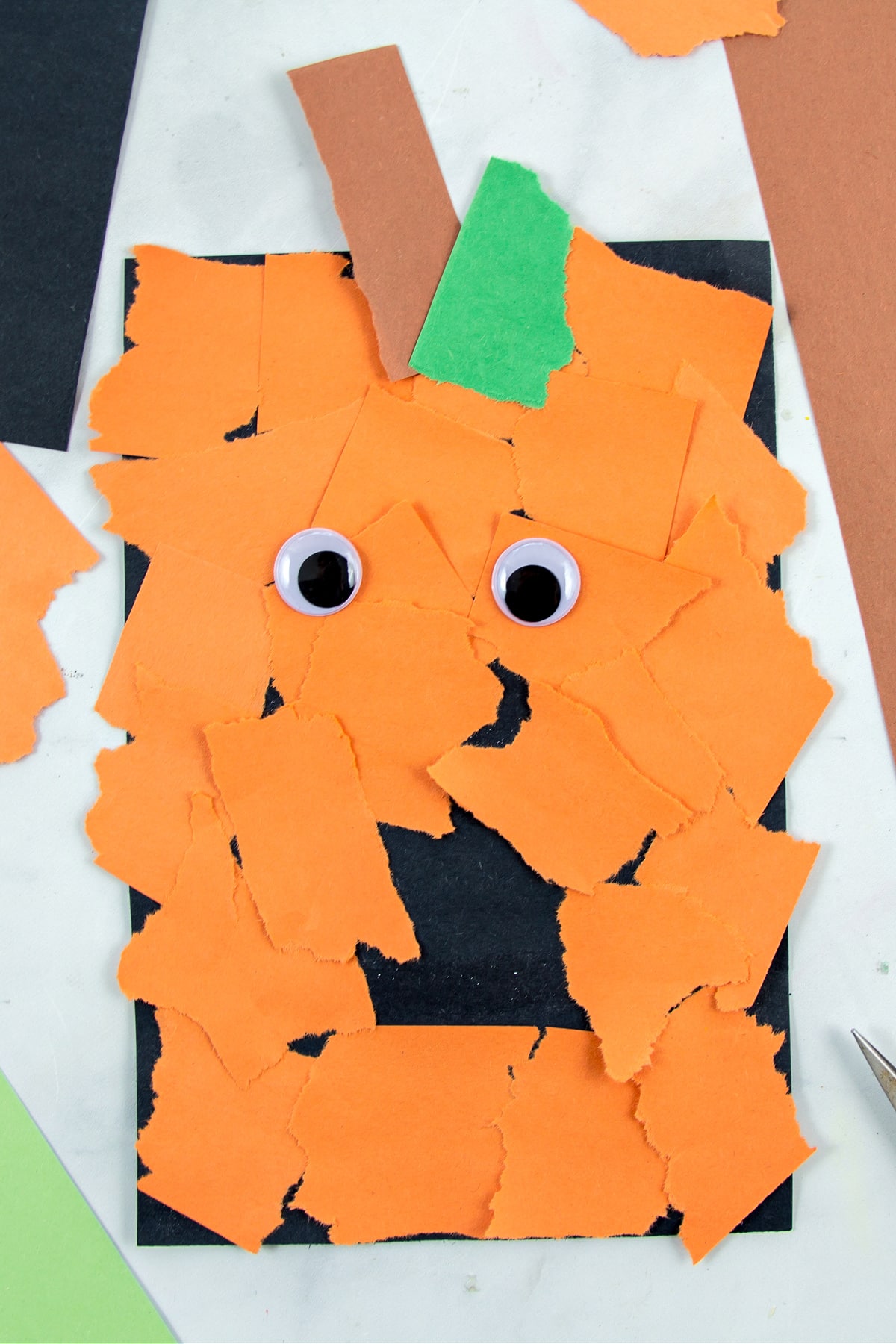 a jack o lantern craft for preschoolers made out of construction paper