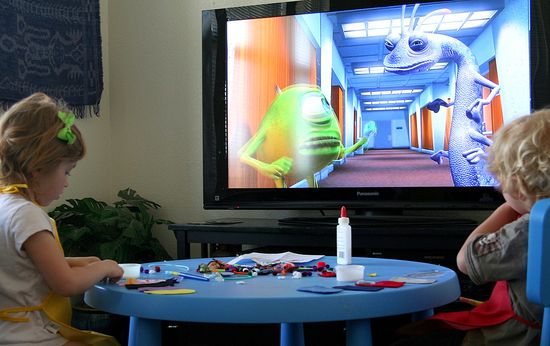 kids doing a craft while watching monsters inc