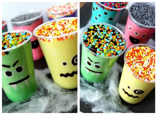 Plastic cups with chocolate monster faces and colorful pudding inside.