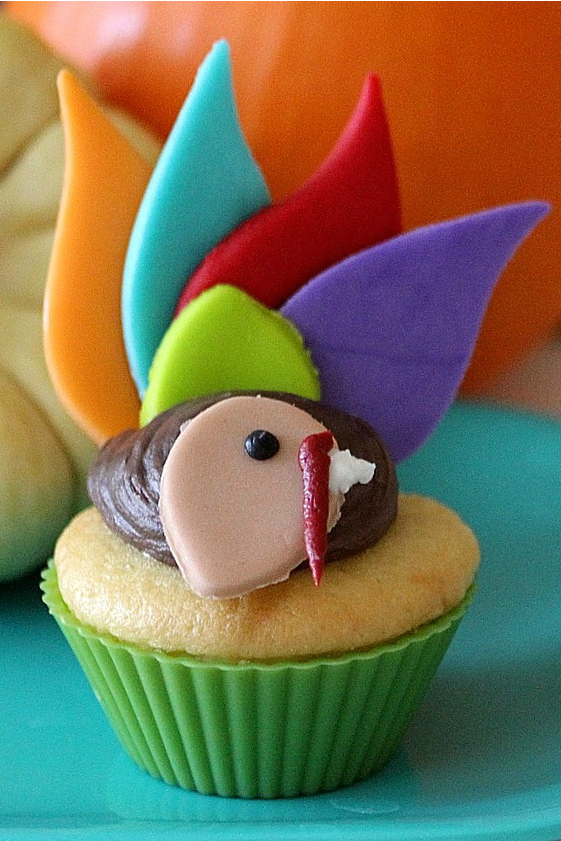 turkey cupcakes with colorful fondant feathers