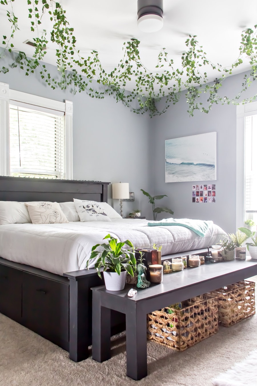 bedroom idea teenage girl with black furniture, grey walls, white decor, plants on the ceiling, and decorations.