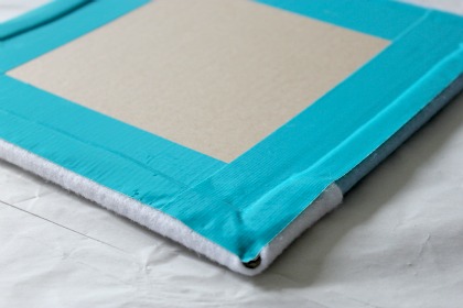 Use tape to attach felt to cardboard to make a felt board.