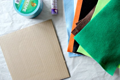 Cardboard, felt, tape, and glue to make a felt board for kids