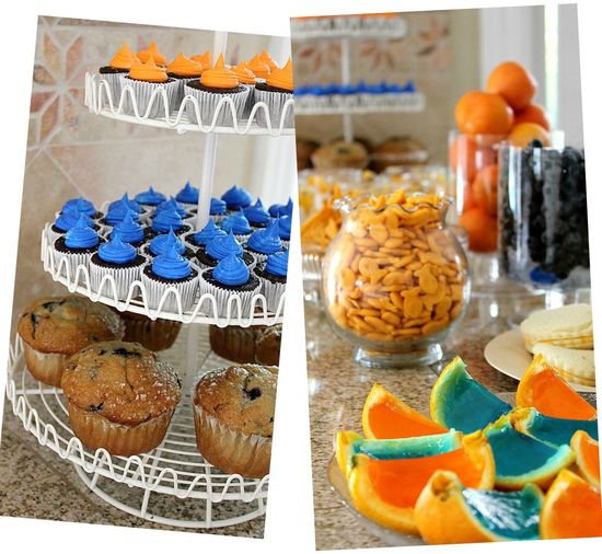 orange and blue party food including cupcakes, jelly orange slices, goldfish, fruit, and muffins.