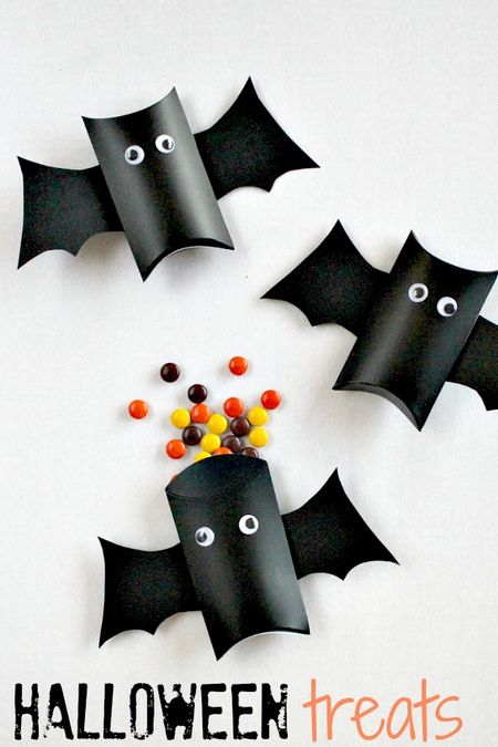 Instructions to make a Halloween bat craft treat container that can be filled with candy.