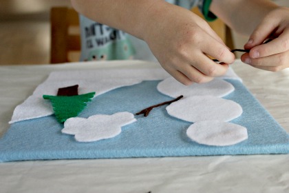 Cut felt into shapes to use on a felt board.