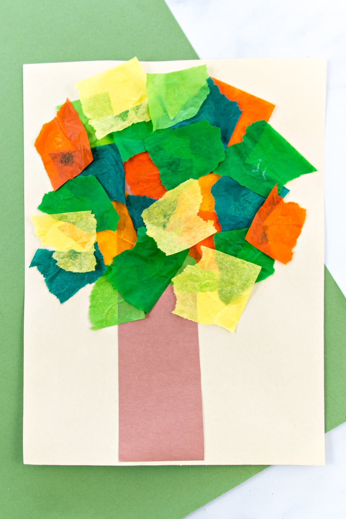 Fall tree craft for preschoolers using brown construction paper and colorful tissue paper