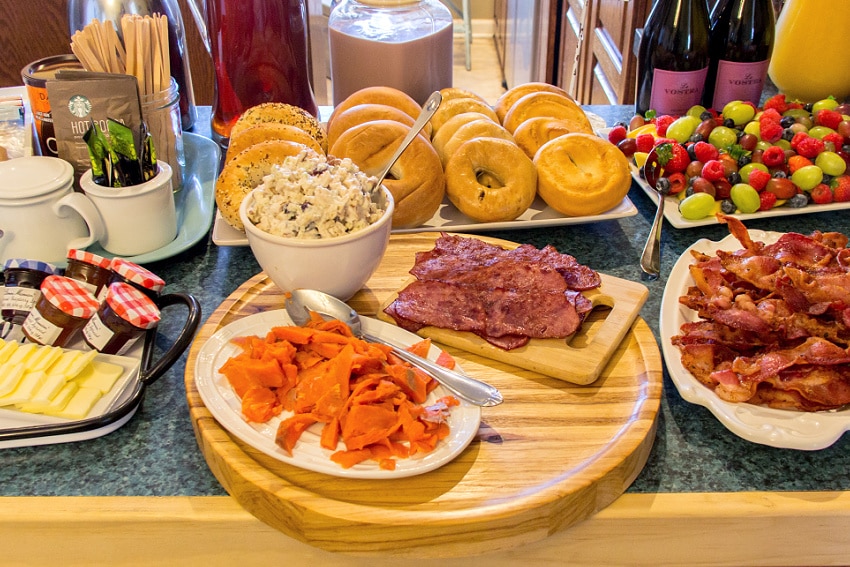 thanksgiving brunch bagel bar with turkey salad, salmon, bacon, and other assorted toppings