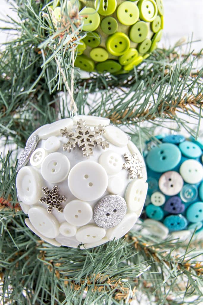 diy button ornaments using paper mache balls with buttons glued all over them