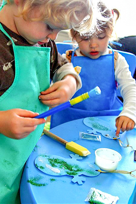 kids making foam snowman ornaments to hang on the christmas tree