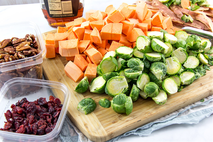 Ingredients to make roasted sweet potato and brussels sprouts side dish for Thanksgiving.