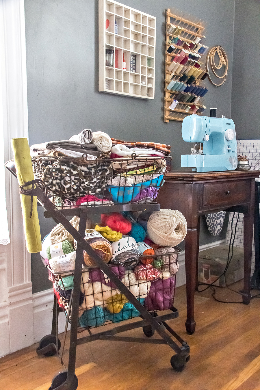 sewing room ideas including a vintage shopping cart for yarn and fabric