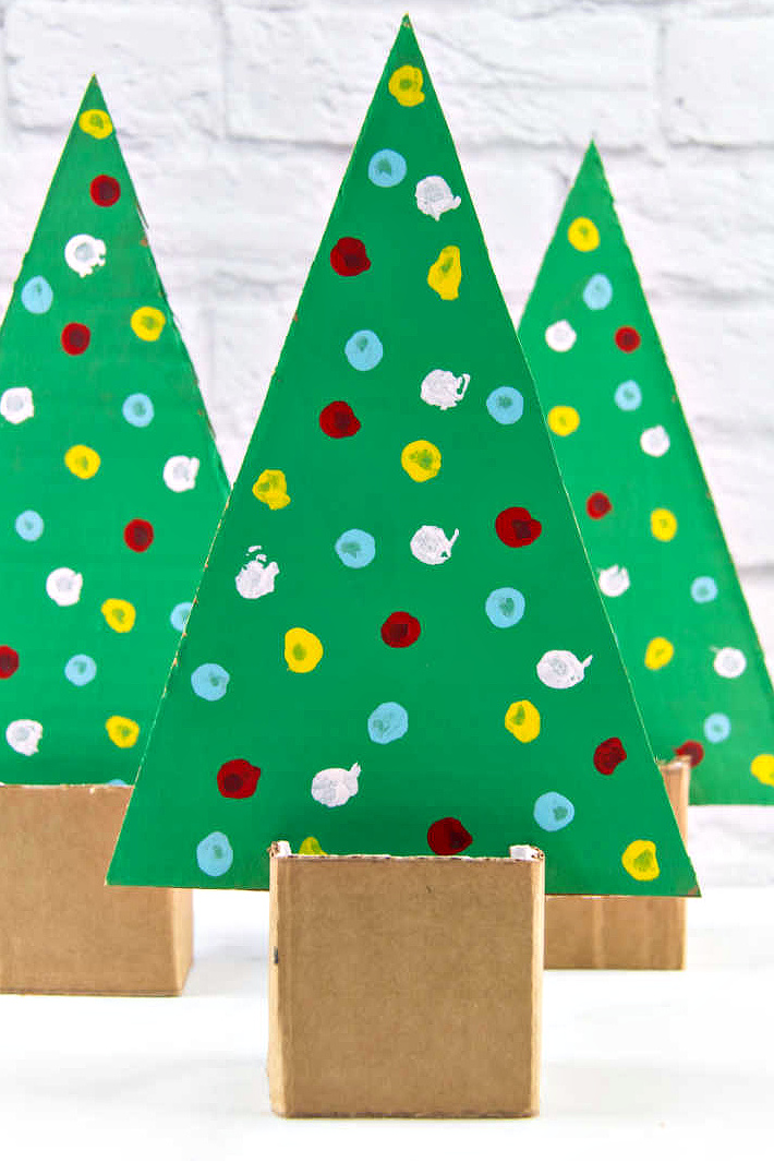 a Christmas tree made out of a repurposed cardboard box by preschoolers