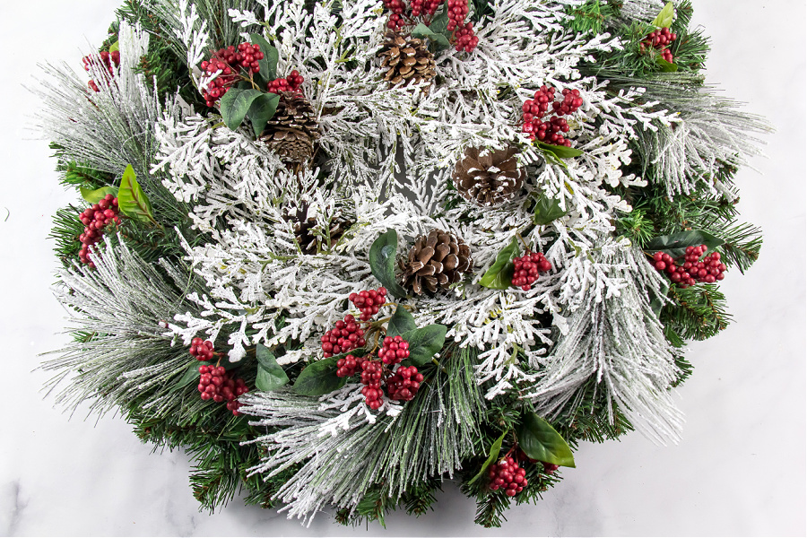 a red, green, and white snowy christmas wreath