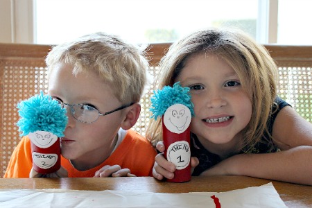 Toilet paper rolls painted and topped with pom poms to look like Dr Seuss Thing 1 and Thing 2.