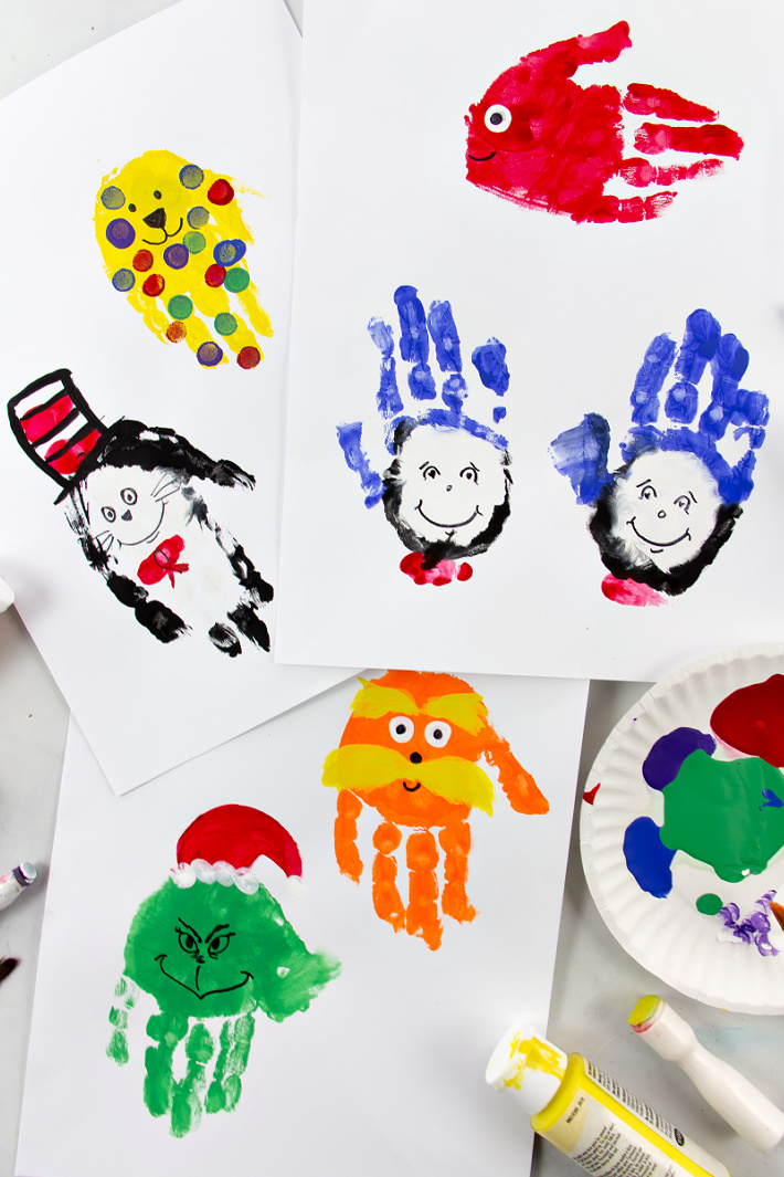 Dr Seuss handprint art including The Lorax, The Grinch, Cat in the Hat, Red Fish, Spot, and Thing 1 and Thing 2