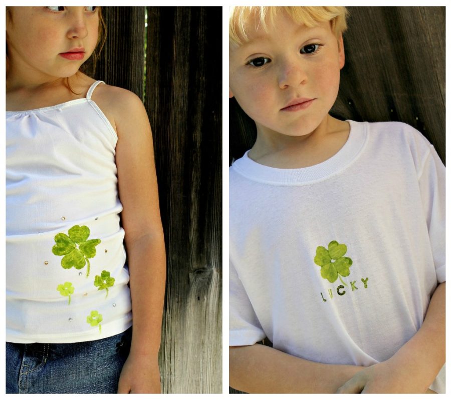 Kids wearing white shirts that have been stamped with four leaf clovers using handmade stamps and fabric paint.