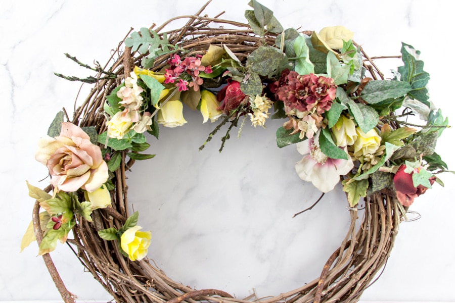 A grapevine wreath purchased at a thrift store for upcycling