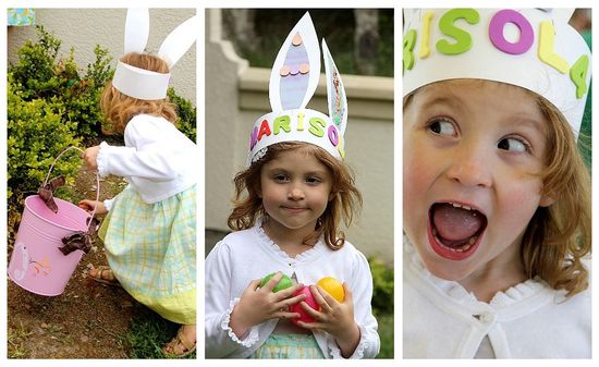 A little girl wearing a hand decorated bunny ears headband made out of poster board.