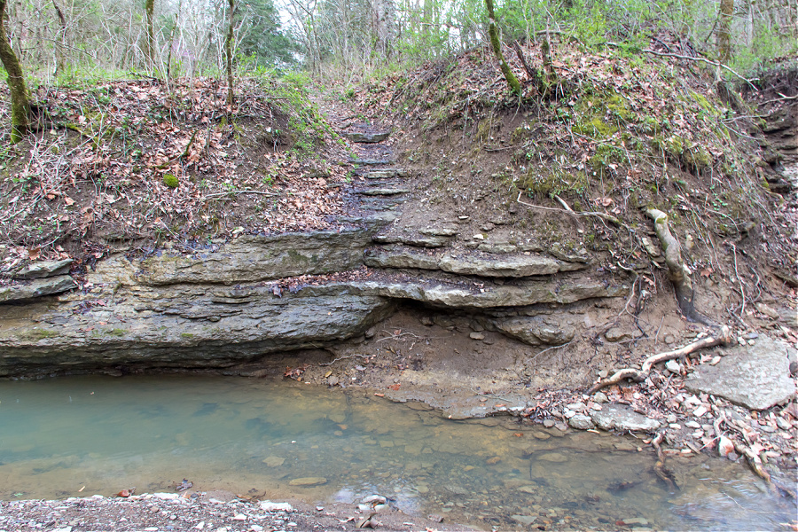 A rocky ledge that leads to the creelsboro natural arch