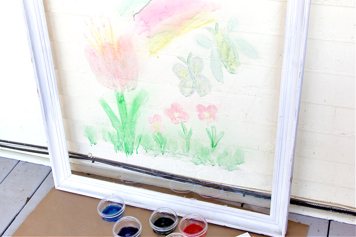 homemade window paint for kids that's been painted on a glass frame