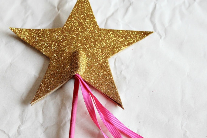 Glue gold foam stars onto the pink dowel rod to turn it into a wand.