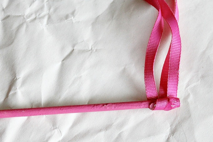 Wrap pink ribbon around a pink dowel rod and glue it into place for the wand.