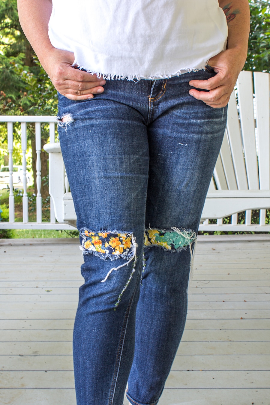 Women's denim jeans that have been patched with a floral canvas fabric. 