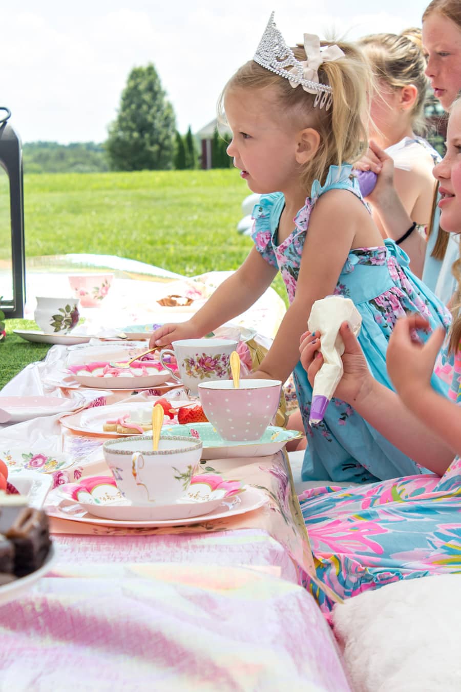 pink, blue, and purple tea party ideas for kids on a pallet picnic table.