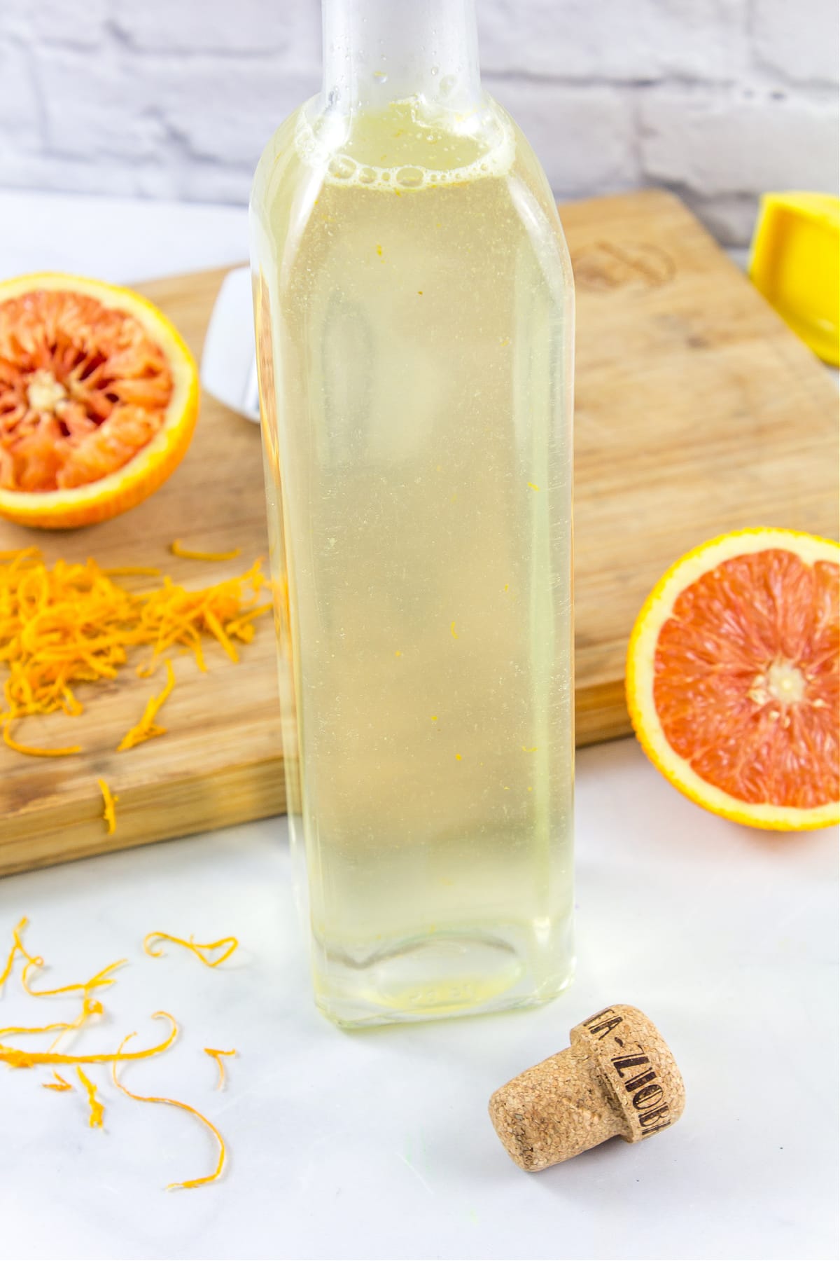 homemade orange simple syrup in a glass bottle