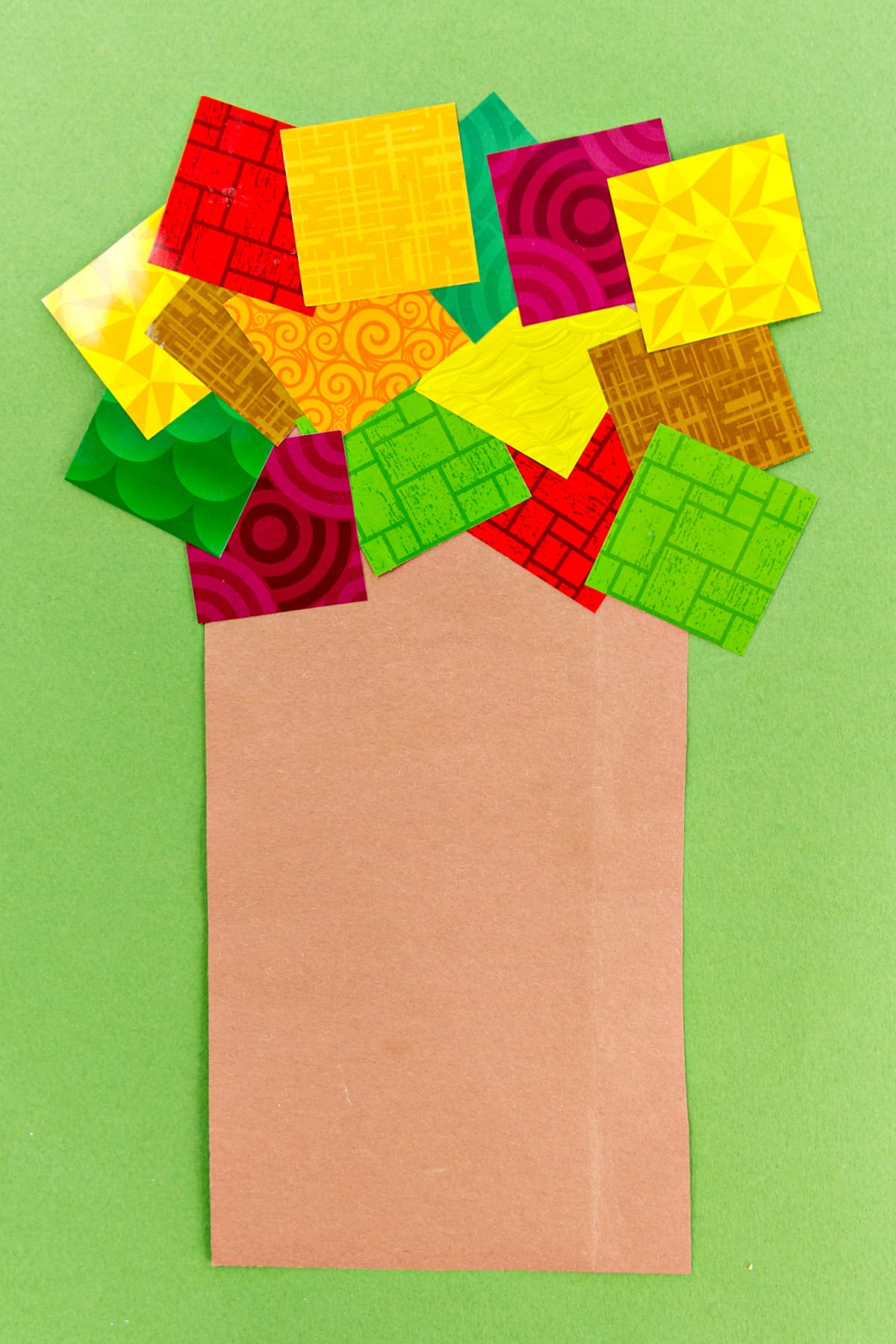 A paper tree craft made with construction paper and scrap paper squares
