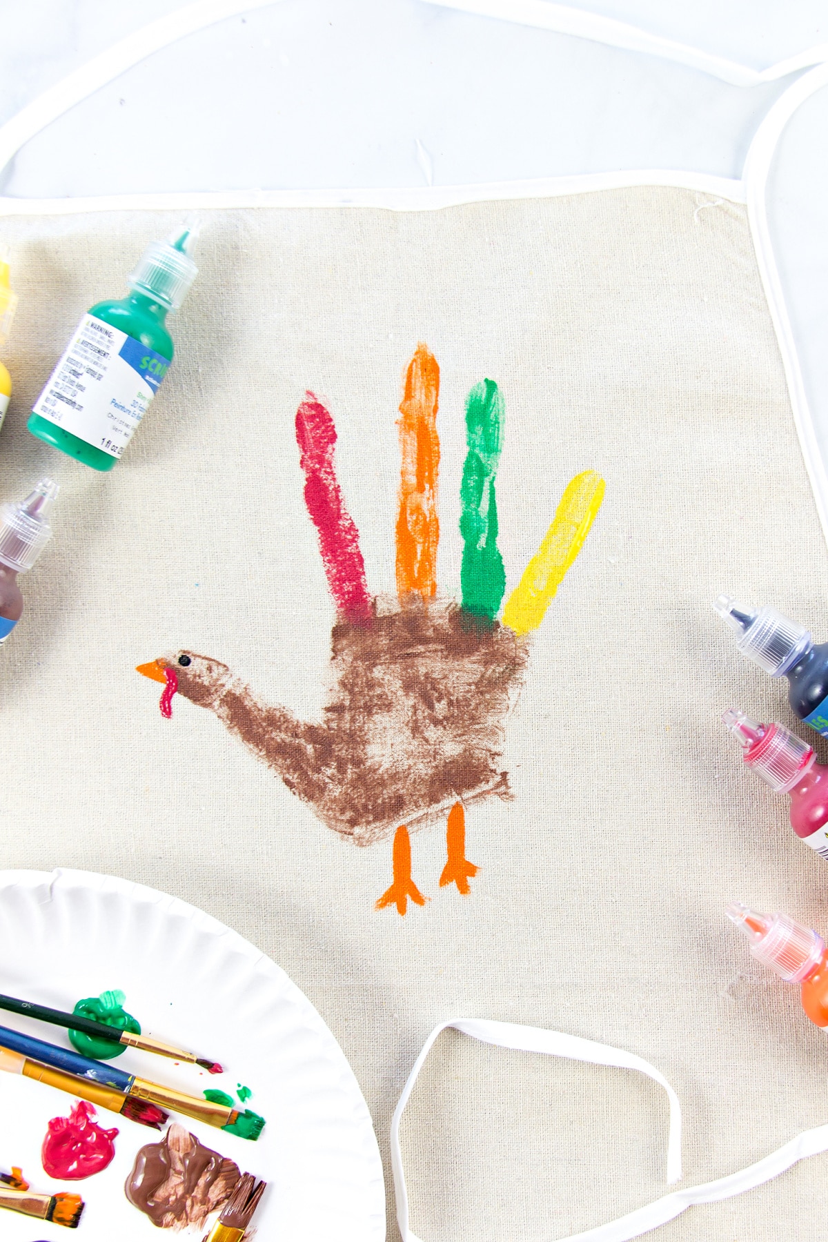 an apron with a handprint turkey on it for Thanksgiving baking
