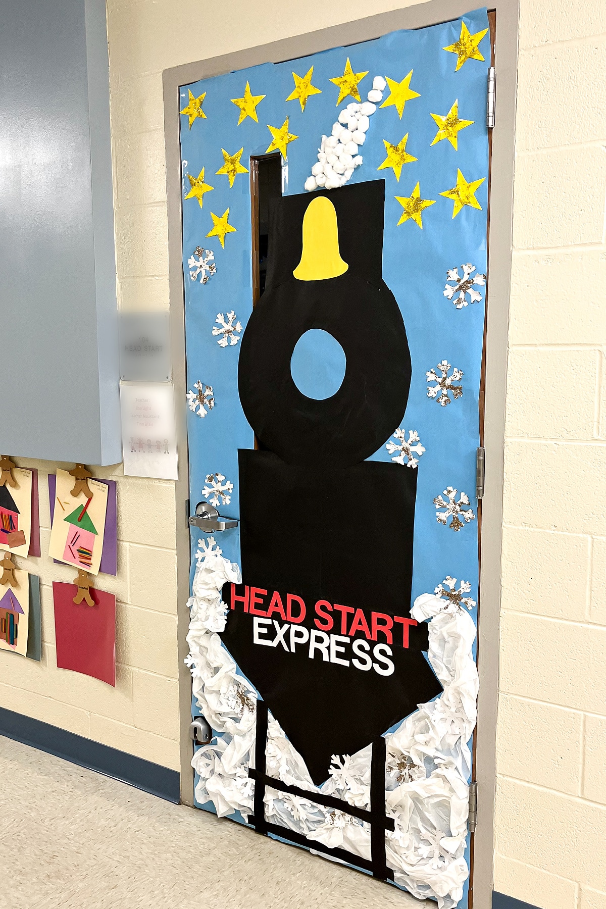 a preschool classroom door decorated with a train and snow like the polar express for winter