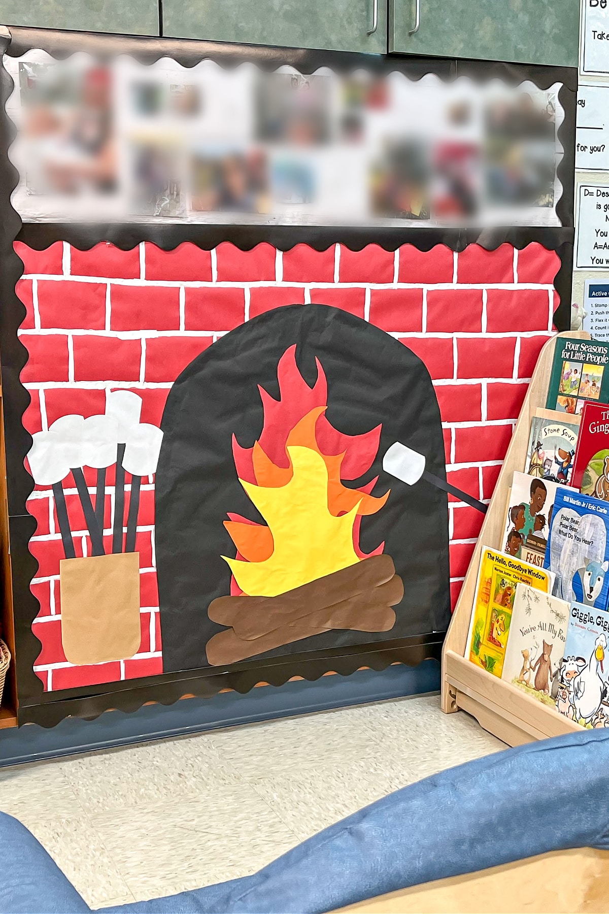 A construction paper fireplace backdrop for a classroom library to make a cozy reading corner for kids