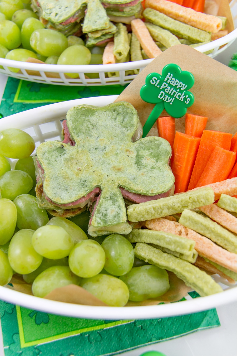 healthy st patricks day lunch for kids including a shamrock quesadilla, veggie straws, carrots, and grapes