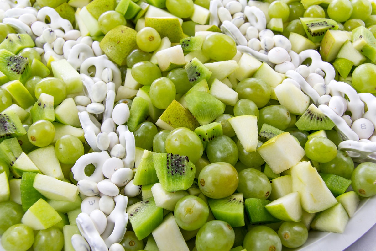 a round fruit tray with green fruit for a tennis themed party