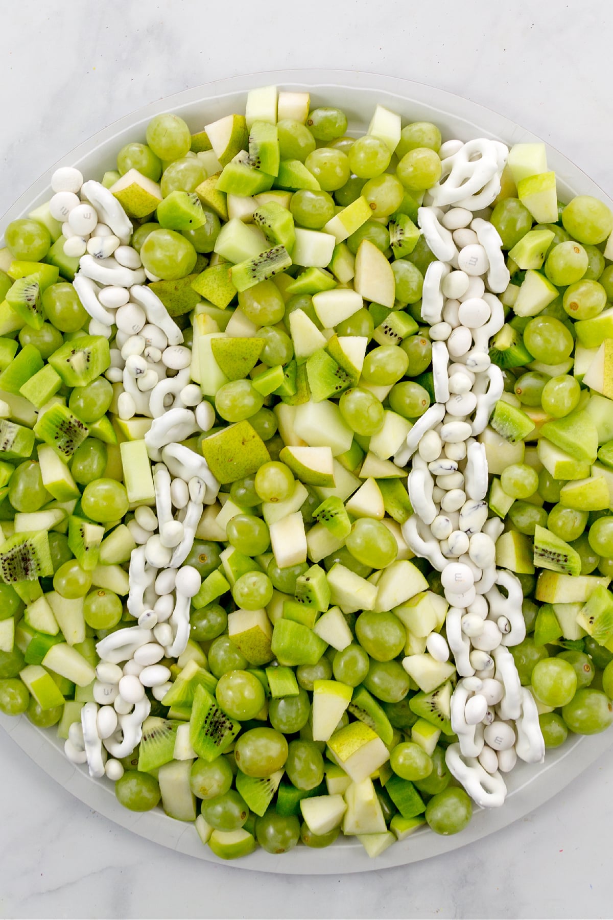 a fruit tray shaped like a tennis ball for a tennis party