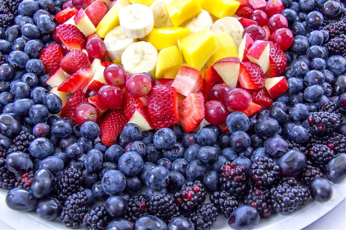 yellow fruit, red fruit, blue fruit, and black fruit arranged like an archery bullseye target