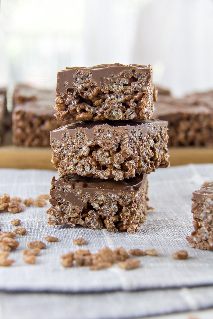 chocolate rice krispies squares with a layer of chocolate on top 