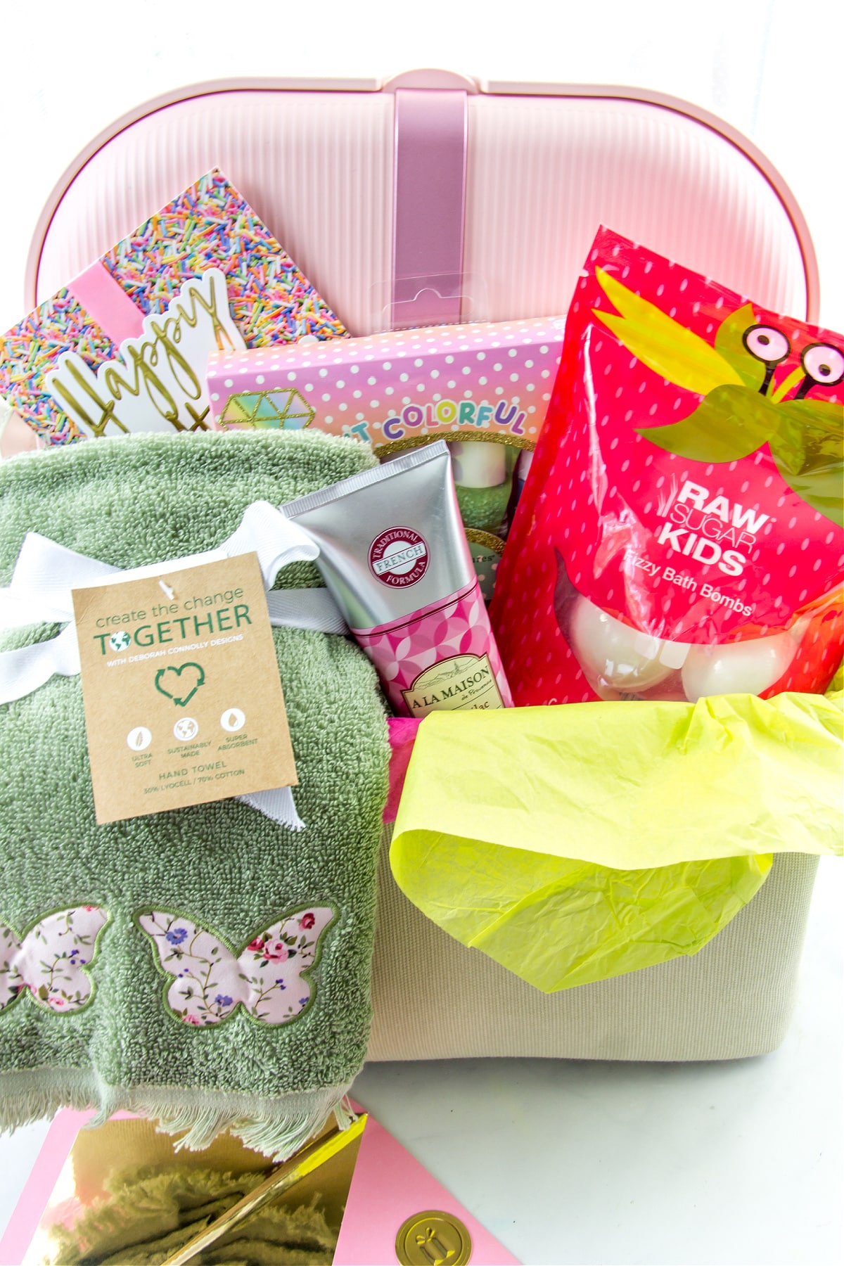 a foot spa gift basket for little girls including a collapsible foot spa, bath bombs, lotion, nail polish, and towels.