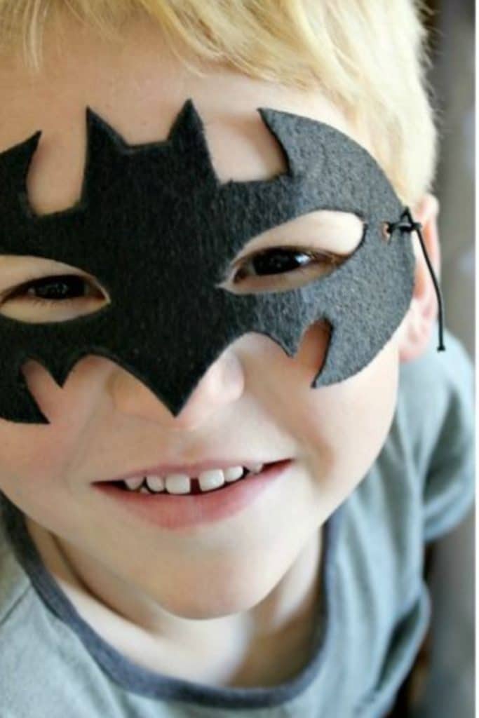 boy wearing a homemade felt Batman mask
