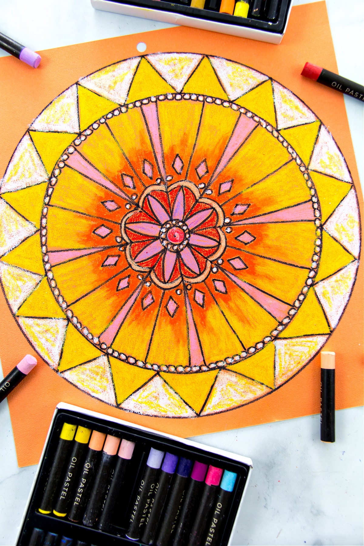 color in your mandala design using oil pastels