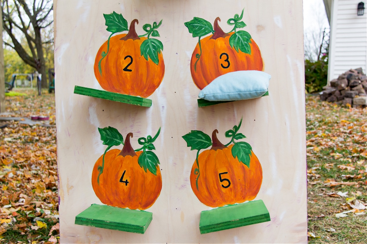 diy pumpkin bean bag toss game for kids that can be used at a fall festival