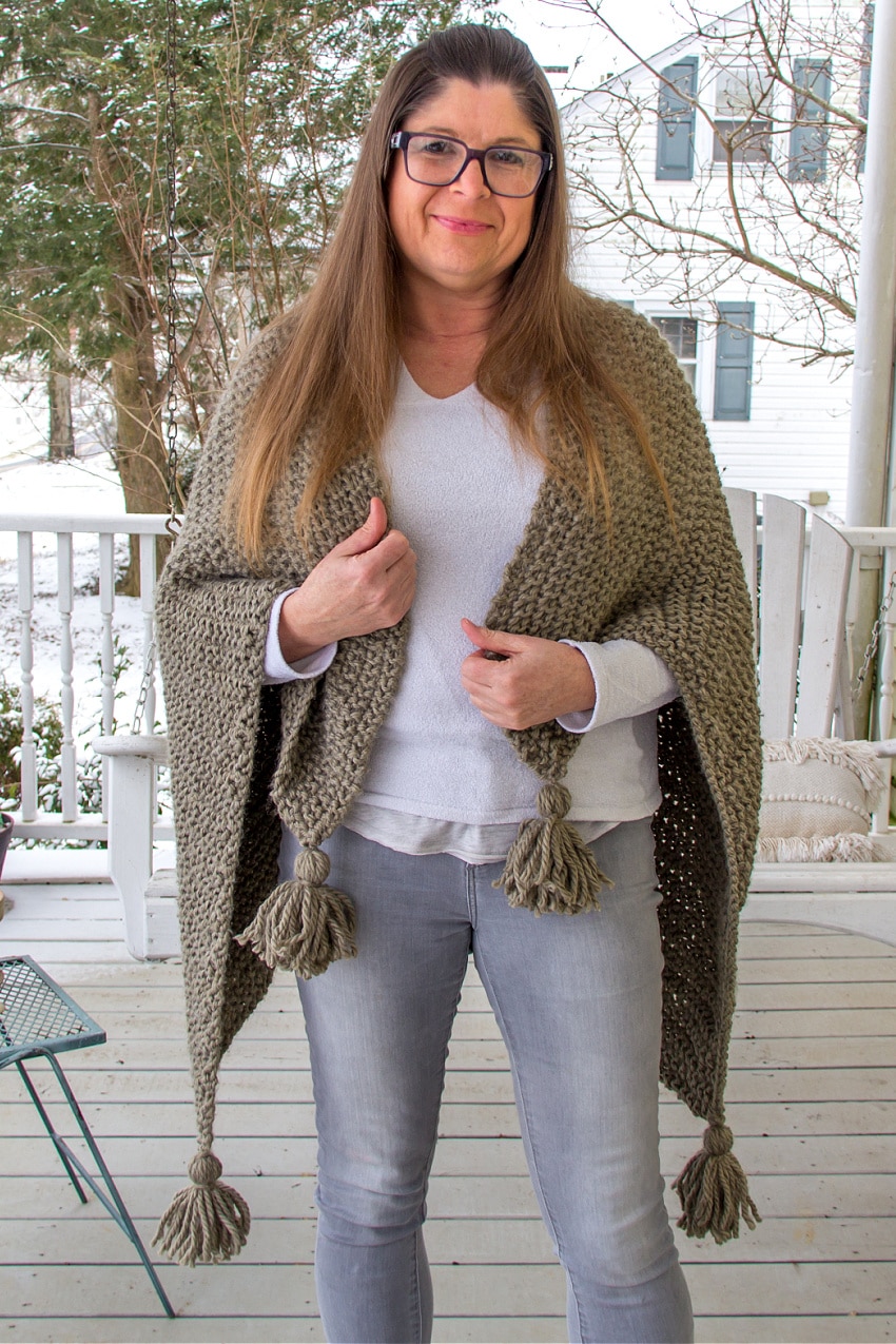 a handmade knit blanket scarf in olive green.