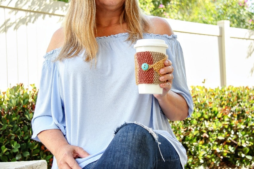 a handmade knit travel mug cozy in fall colors