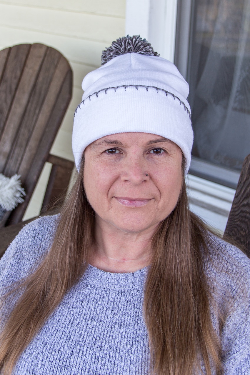 Embellish a beanie with a pom pom and embroidery. 