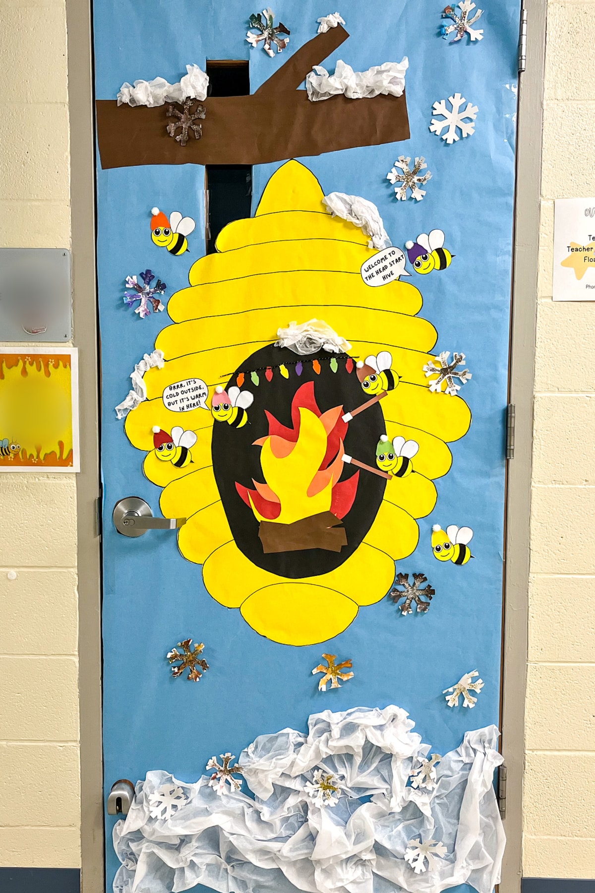 winter bee theme classroom door with bees toasting marshmallows in their hive