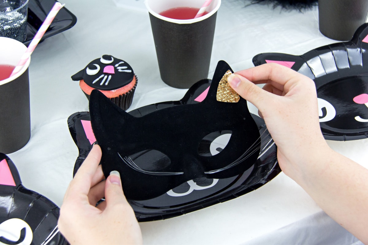 a black cat mask being decorated for halloween