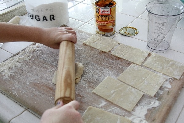 pastry being rolled out and cut into rectangles to make homemade pop tarts